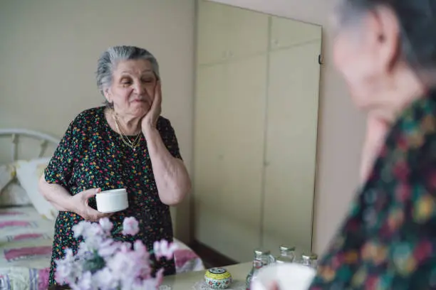 Senior Woman Applying Face Cream