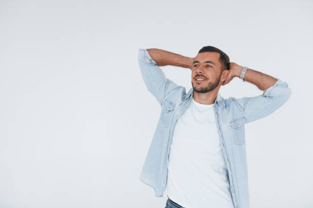 istock Feels relaxed. Young handsome man standing indoors against white background 1331953502