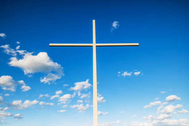 Christian cross against sky and clouds