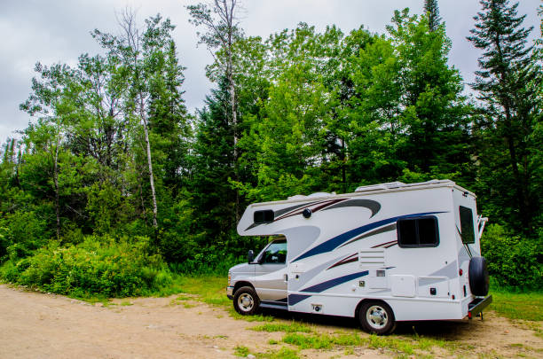 istock Motor home parked in forest 1331957361
