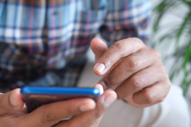 istock Close up of young man hand using smart phone. 1331958344