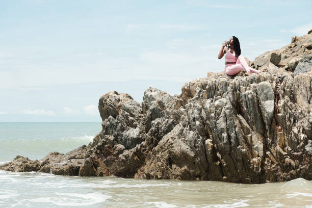 istock Female Jogger Resting on Rocks 1331962910