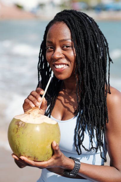 istock Sportswoman Holding Coconut with Straw 1331962930