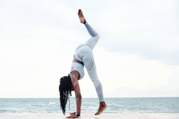 istock Sportswoman Trying to Do Handstand 1331962964