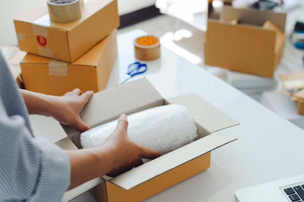 istock female warehouse worker are checking or seller packing ecommerce shipping order box for dispatching, preparing post courier delivery package or online sales, e-commerce concept. 1331964370