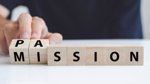 hand of a man who turning a wooden block with the word passion and mission. hand turns wooden block and changes the name "mission" to "passion". - determination imagens e fotografias de stock