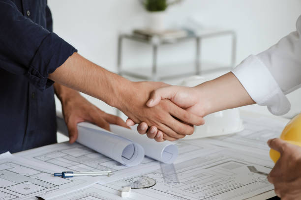 istock Two engineer or architect meeting and greeting handshake after consultation and conference new project plan, makeing contract of both companies for partnership to success. 1331964969