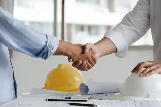 istock Two engineer or architect meeting and greeting handshake after consultation and conference new project plan, makeing contract of both companies for partnership to success. 1331965291