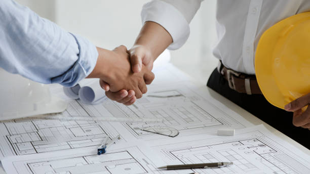 istock Two engineer or architect meeting and greeting handshake after consultation and conference new project plan, makeing contract of both companies for partnership to success. 1331965299