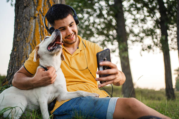 istock Young man taking selfie with dog in nature 1331966277