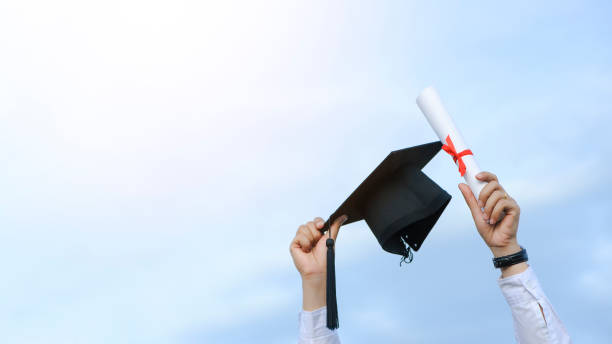 istock Graduates are celebrating graduation put a hand up, a certificate, and a hat in hand with happiness feeling in Commencement day, Congratulation, Graduation day concept 1331966294