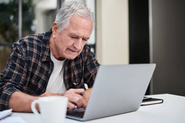 istock Shot of a senior man using a laptop at home 1331966770