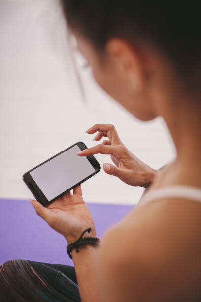 istock Woman using mobile phone at fitness studio 1331968885