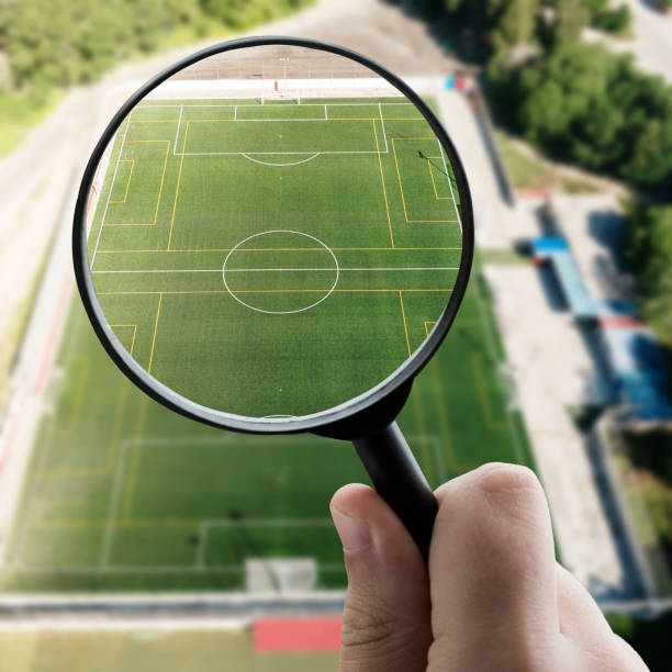 istock Magnifying glass focusing a soccer field from above 1331969228