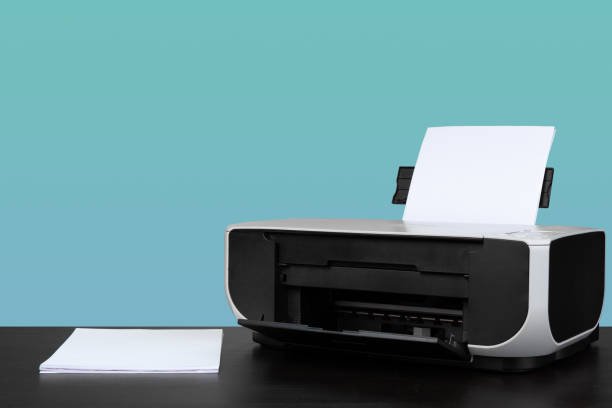 istock Home laser printer on desk against green background 1331969437