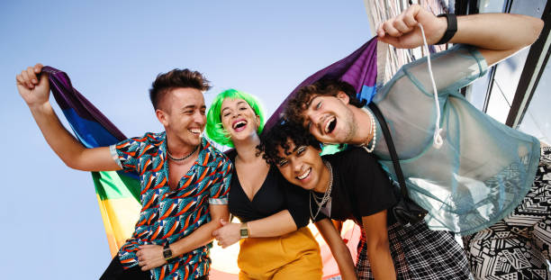 istock Group of LGBTQ+ people celebrating with pride flag 1331970721