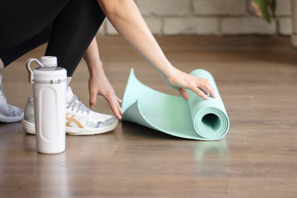 istock coach preparing fitness mat for exercising 1331971380