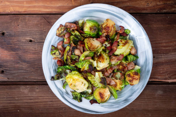 grilled brussels sprouts with bacon on a rustic table - pancetta imagens e fotografias de stock
