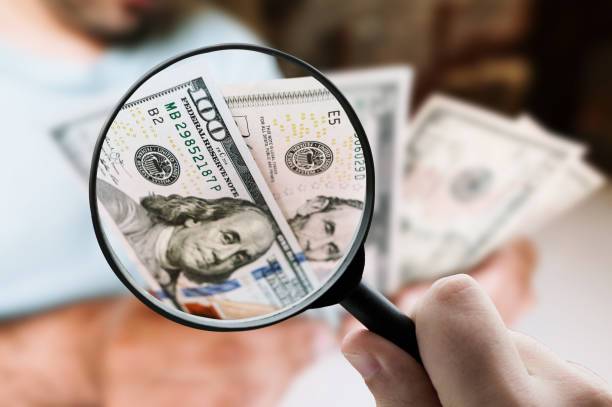 istock Magnifying glass focusing on money 1331973901