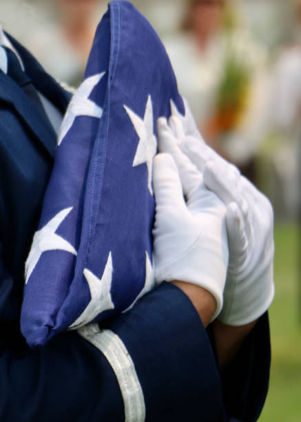 uniformed male carrying folded american flag - depression sadness usa american flag imagens e fotografias de stock