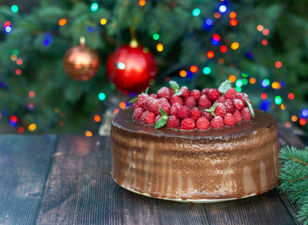istock Christmas chocolate cake with icing, decorated with fresh strawberries and mint leaves. 1331974961