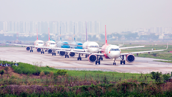 Ho Chi Minh city, April 27th 2021: many airplanes of many airlines were in queue for rolling to runway 25L for departing in the haze morning.