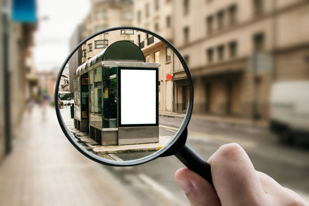 istock Magnifying glass focusing a bus stop with billboard 1331976432
