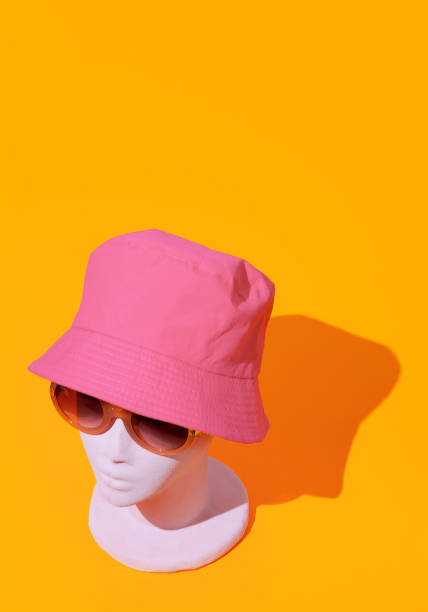 Dummy fashion girl in stylish summer sunglasses and bucket hat. Party shop, vacation, holiday concept.  Minimalist isometric wallpaper. Dummy fashion girl in stylish summer sunglasses and bucket hat. Party shop, vacation, holiday concept.  Minimalist isometric wallpaper. bucket hat stock pictures, royalty-free photos & images