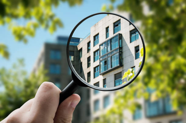 istock Magnifying glass focusing a modern apartment building facade 1331976669
