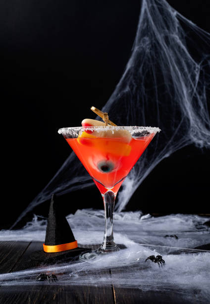 istock Scary colorful Halloween cocktail with party decorations on dark background with copy space 1331977548