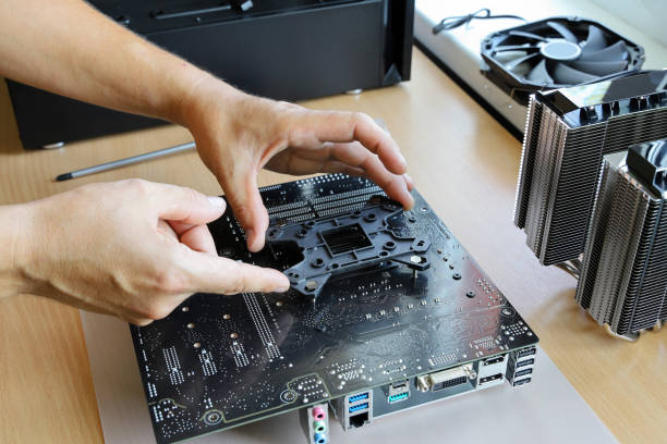 istock Hands install backplate on back of motherboard for fastening cooler processor 1331978255