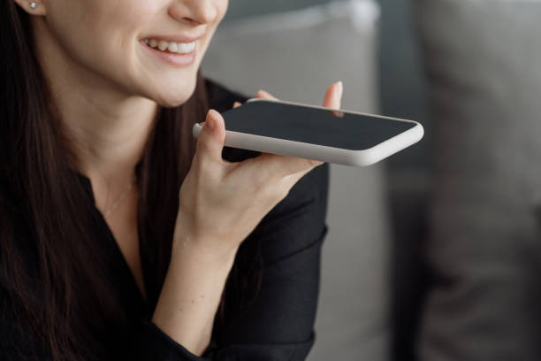 istock Woman using loudspeaker of smartphone while sitting on sofa 1331978332