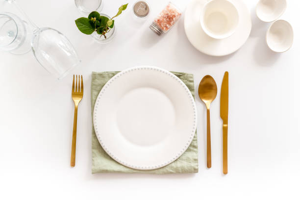 istock Eating utensil set - table setting for dinner with plate on napkin 1331978494