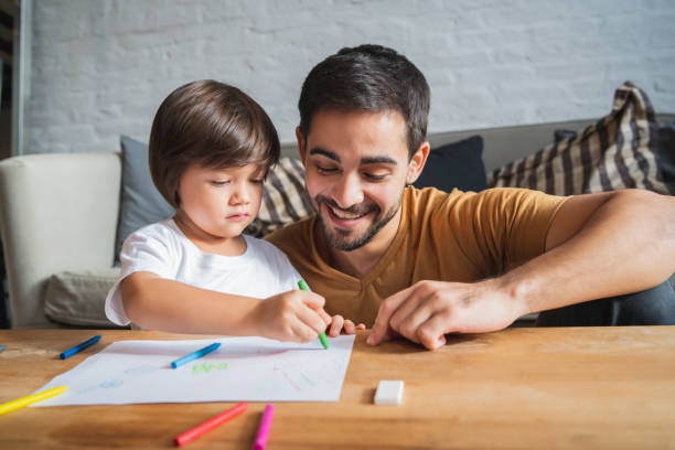 istock Little boy having fun with his father at home. 1331979395
