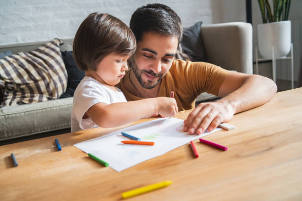 istock Little boy having fun with his father at home. 1331979400