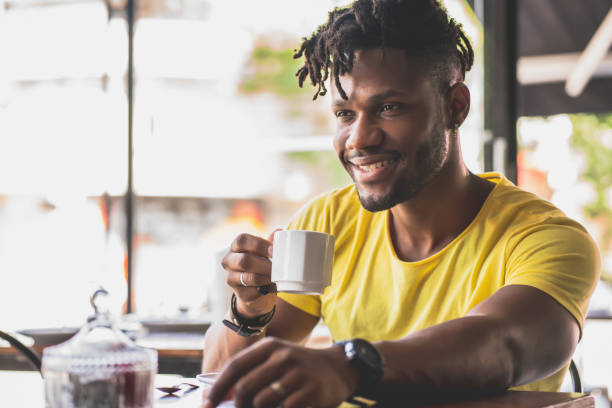 istock Man drinking a cup of coffee at a coffee shop. 1331979444