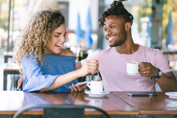 istock Young couple drinking coffee at a coffee shop. 1331979457