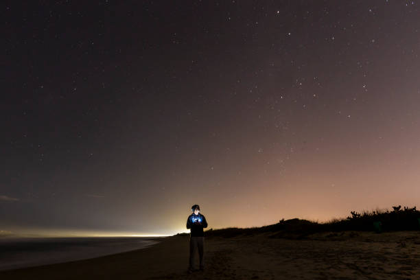 istock boy in starry sky on the beach 1331980663