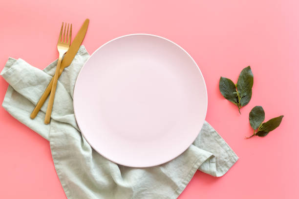 istock Dinner plate setting with cutlery and napkin. Top view 1331981785