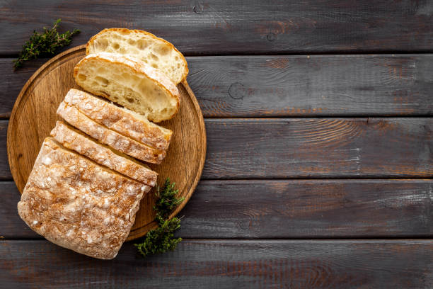 istock Freashly backed bread slice on cutting board, top view 1331985038