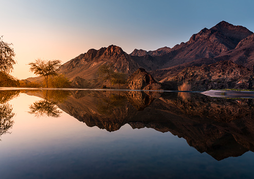 Mountain Landscape view with beautiful water reflections, click from Hatta Lake, Morning nature beauty