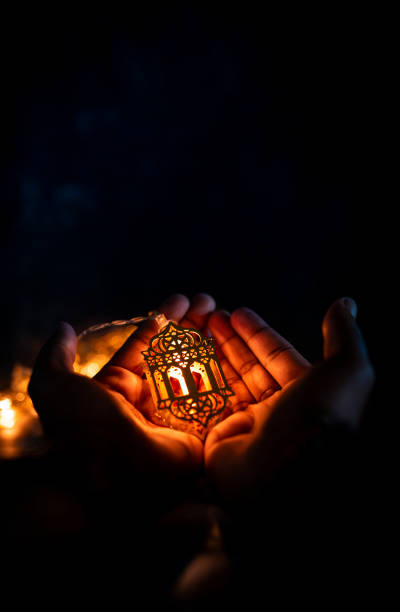 istock Holding beautiful lantern light lamp, ramadan concept background 1331985363