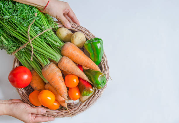 istock A basket of fresh vegetables in your hands on a white background. 1331986567