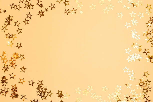 istock Border frame made of gold colored stars confetti. 1331986617