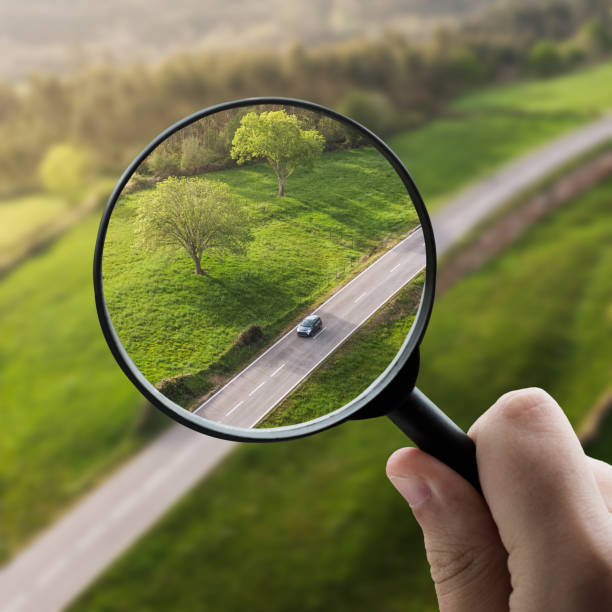 istock Magnifying glass focusing a car on a road 1331988755