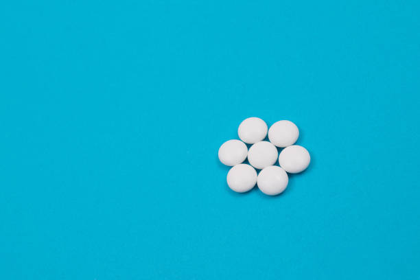istock Pharmaceutical Industry and Medicinal Products - White Pills on Blue Table 1331989693