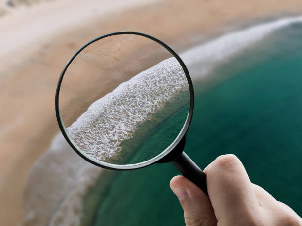 istock Magnifying glass focusing a beach 1331991586