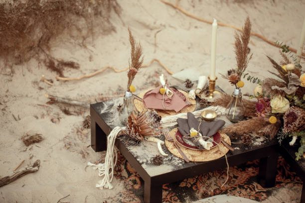 istock A table  designed for a boho style event with an eucalyptus, vintage plates and other rustic touches. On seaside in the sand dunes 1331991623
