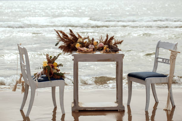 istock A table  designed for a boho style event with an eucalyptus, vintage plates and other rustic touches. On seaside in the sand dunes 1331991638