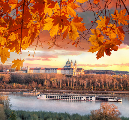 Panorama of Melk abbey with Danube river and autumn forest in Austria